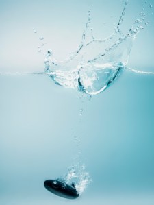 stone sinking water rock